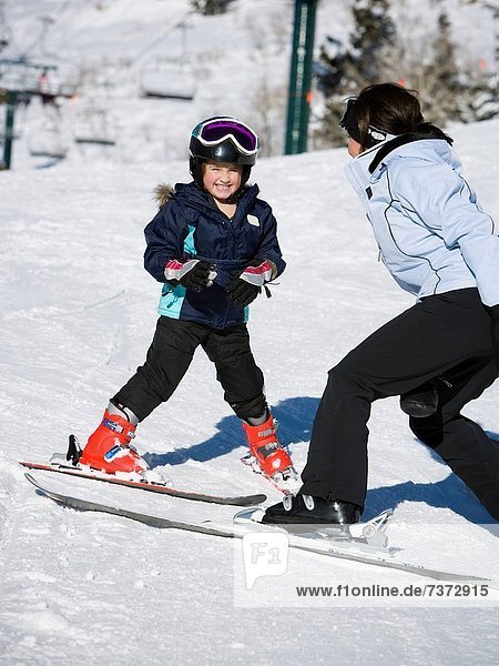 Woman and young girl skiing