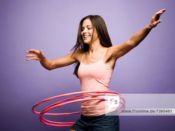 Woman dancing and playing with hula hoops