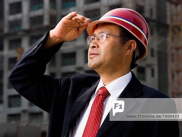 Architect on the job site with a worker.