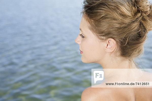 Woman overlooking still lake
