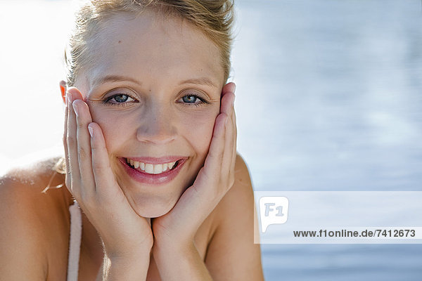 Smiling woman cupping chin in hands