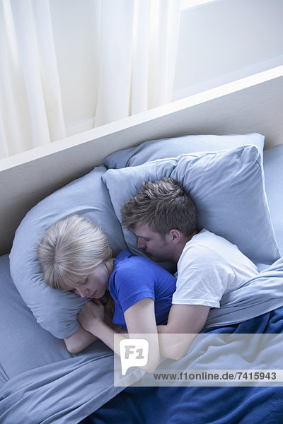 Elevated view of sleeping couple
