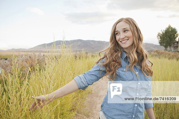 Portrait of young woman on dirt road