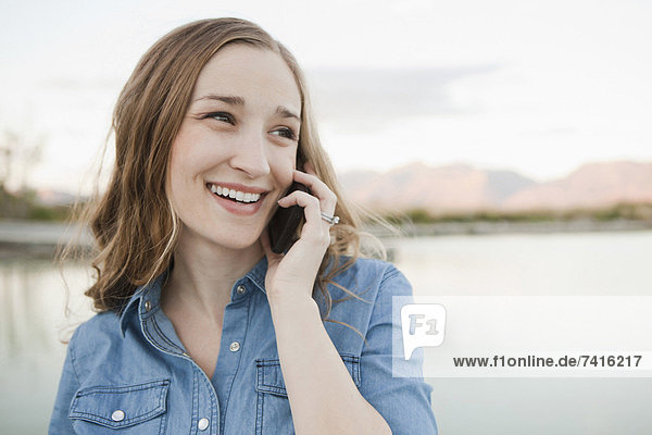 Portrait of young woman talking on phone