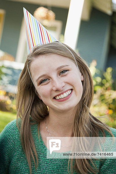 Portrait of young woman in party hat