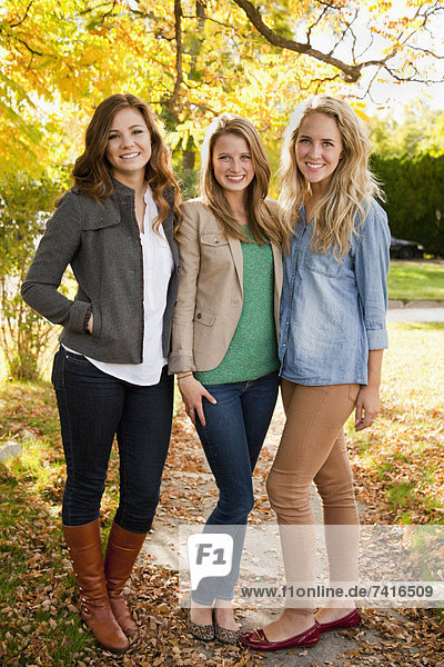 Portrait of three young women in autumn day
