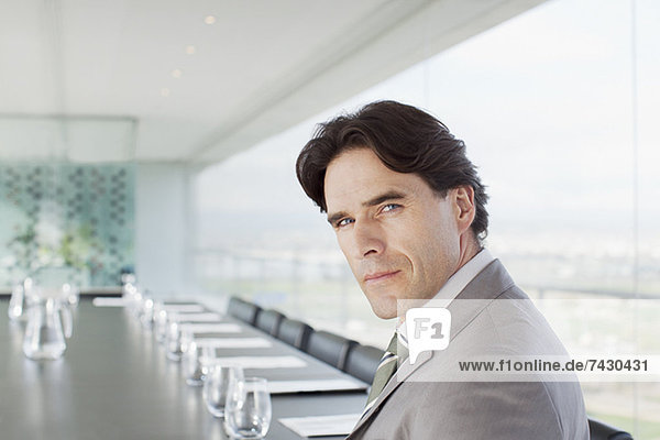 Portrait of confident businessman in conference room