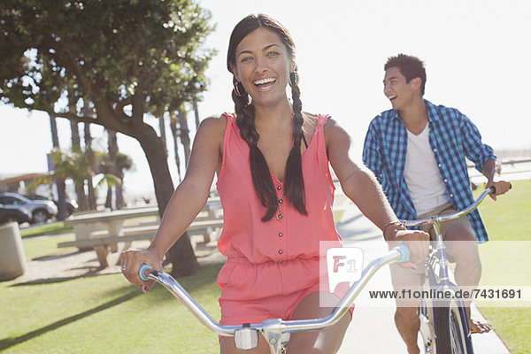 Couple riding bicycles outdoors