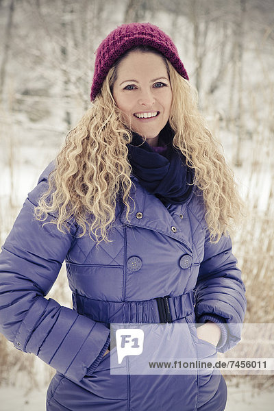 Blond woman wearing winther clothes outdoors