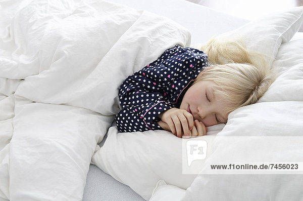 Sleeping girl lying in bed