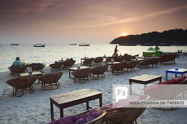 Beach restaurants at dusk on Ochheuteal Beach  Sihanoukville  Cambodia  Indochina  Southeast Asia  Asia