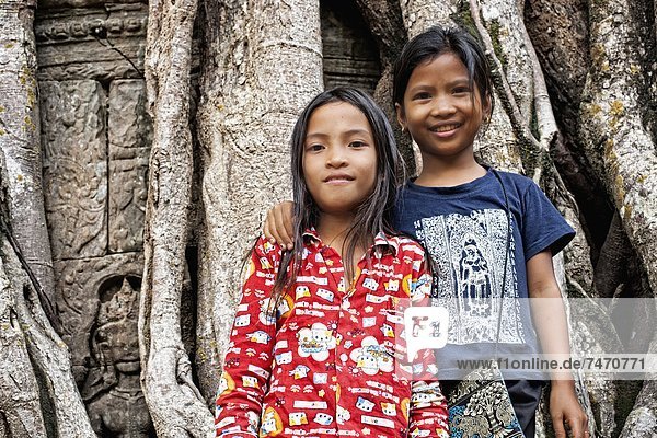 Ta Som  (entrance gate) and two local girls  Angkor  Siem Reap  Cambodia  Indochina  Southeast Asia  Asia