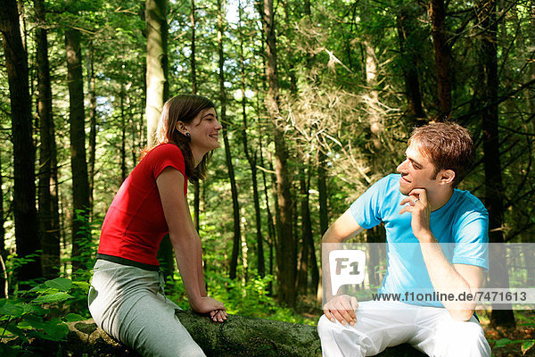 Couple sitting in forest