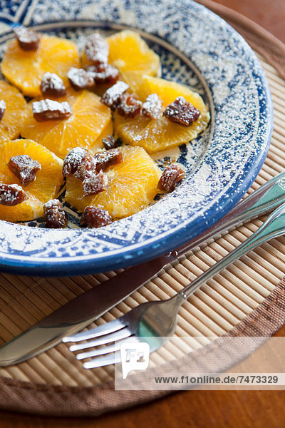Plate of fruit and nuts on placemat
