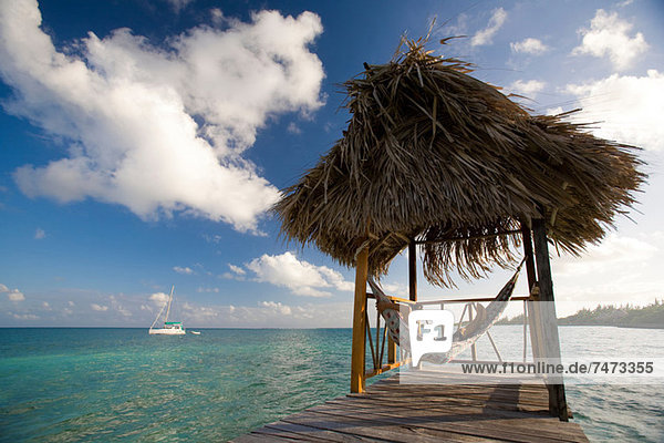 Woman in hammock on tropical water