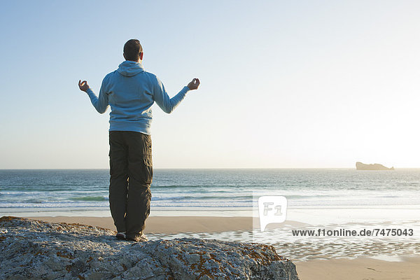 Man Meditating at the Beach  Camaret-sur-Mer  Crozon Peninsula  Finistere  Brittany  France