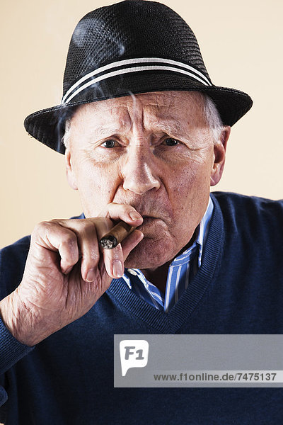 Portrait of Senior Man Smoking Cigar