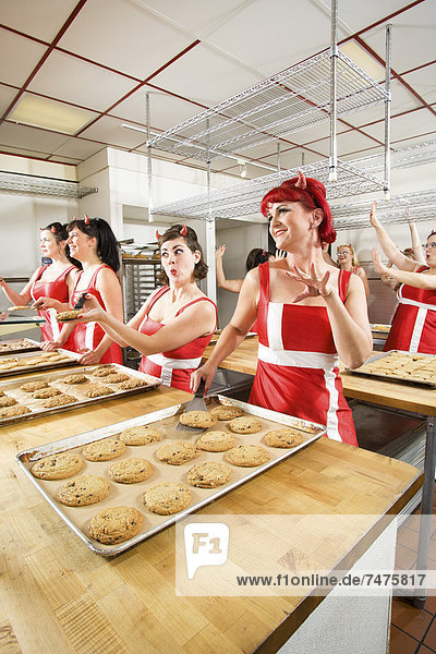Women Wearing Devil Horns at a Bakery  Oakland  Alameda County  California  USA