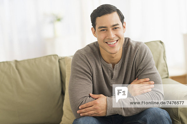 Portrait of smiling man sitting on sofa