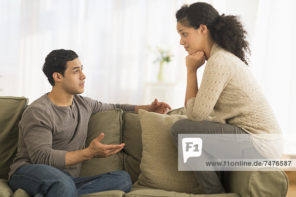 Couple talking on sofa