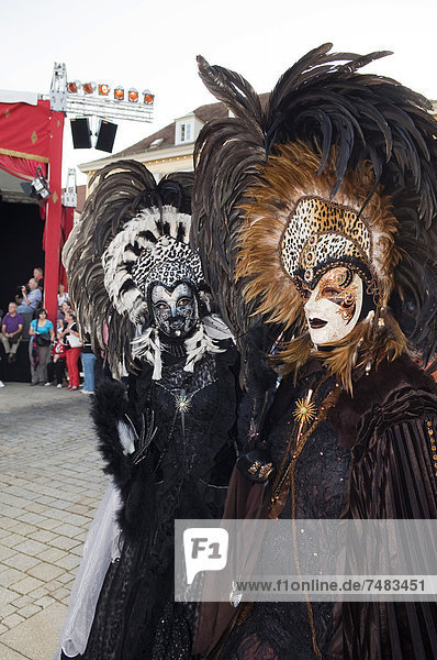 People in Baroque costumes  masks and elaborate headdresses with feathers  Venetian Fair  Ludwigsburg  Baden-Wuerttemberg  Germany  Europe