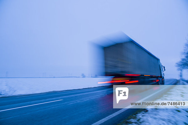 Austria  Cargo truck moving on country road in winter