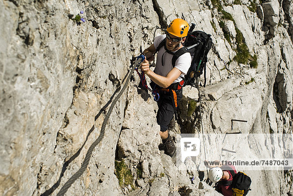 Germany  Bavaria  Mountaineer climbing steep wall