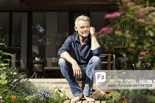 Mature man relaxing on terrace  smiling