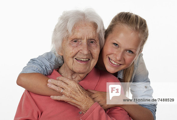 Senior woman and teenage girl  smiling  portrait