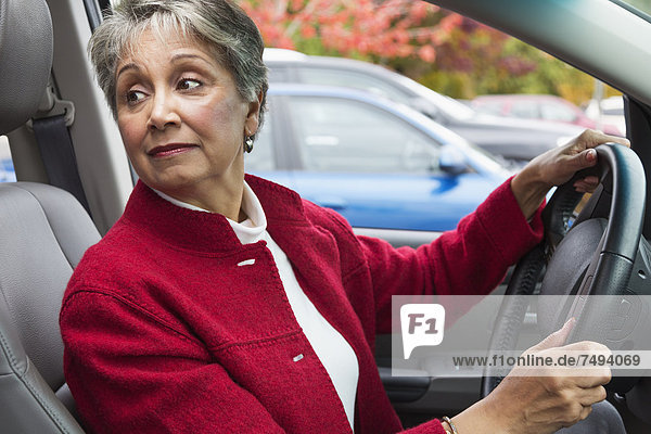Mixed race woman driving in car