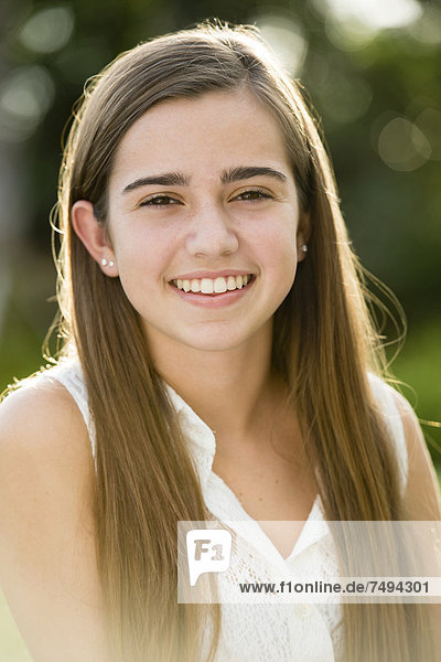 Caucasian teenage girl smiling outdoors
