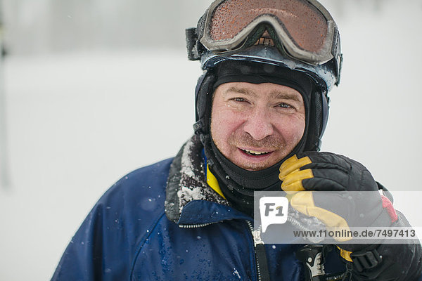 Caucasian man wearing ski gear in snow