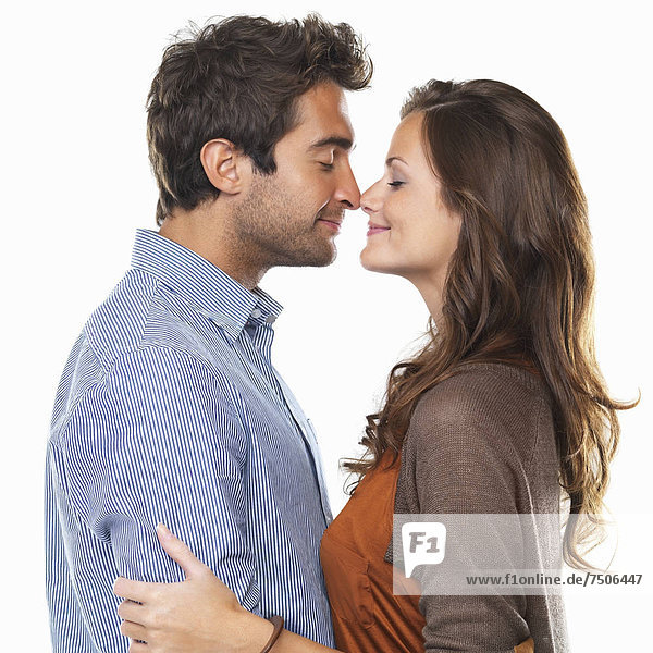 Studio shot of young couple rubbing noses