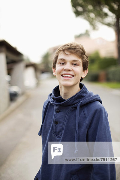 Portrait eines glücklichen Jungen  der auf der Straße steht