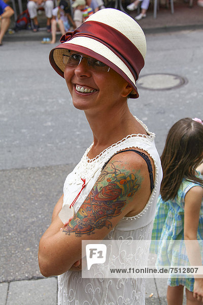 Smiling woman wearing a Panama hat and a summer dress  tattoo  retro look