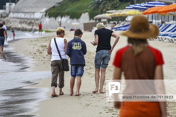 Family  three generations  seeking shells on the beach  Cote d'Azur  France  Europe