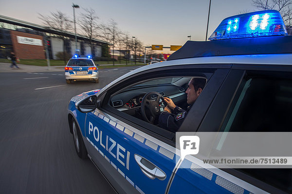 Police patrol car in an emergency operation  with blue lights and sirens  Germany  Europe
