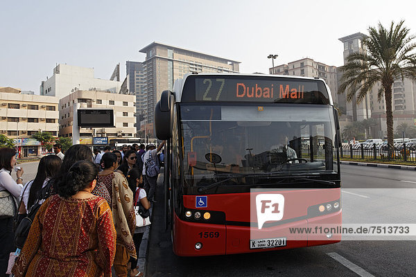People getting on a bus to Dubai Mall  Union Square  Deira district  Dubai  United Arab Emirates  Middle East  Asia