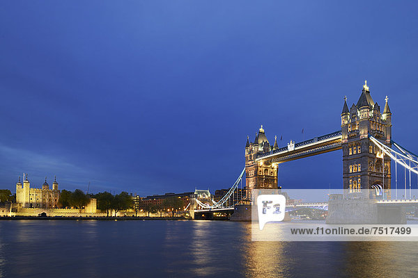 Tower Bridge with the towers of the Tower of London on the left  at dusk  London  England  United Kingdom  Europe