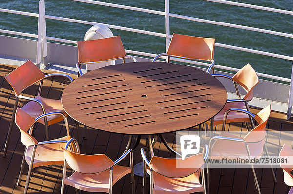 View over a deck with a table and chairs on a cruise ship in the port of Izmir  Turkey  Asia