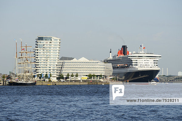 RMS Queen Mary 2 visiting during Hamburg Cruise Days in the Port of Hamburg  with the Marco Polo Tower and the Unilever headquarters