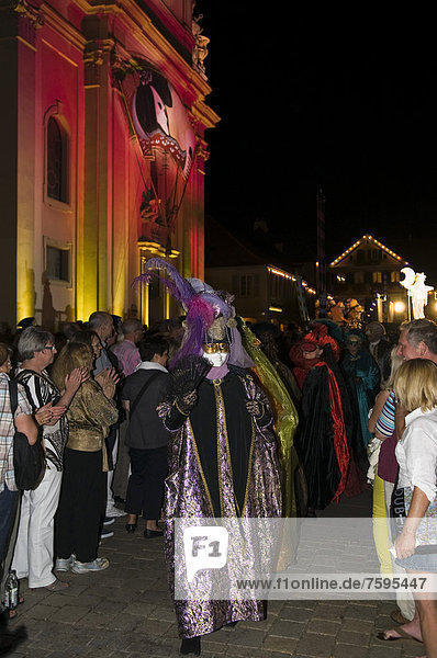 Parade of mask wearers in front of the historic municipal church  Venetian Fair  on the historic Marktplatz market square  Ludwigsburg  Baden-Wuerttemberg  Germany  Europe