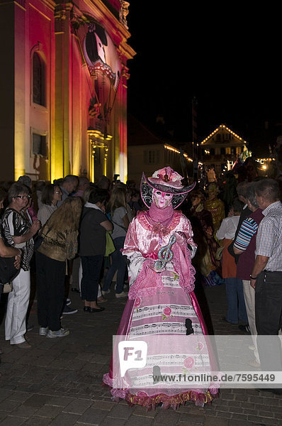 Parade of mask wearers in front of the historic municipal church  Venetian Fair  on the historic Marktplatz market square  Ludwigsburg  Baden-Wuerttemberg  Germany  Europe