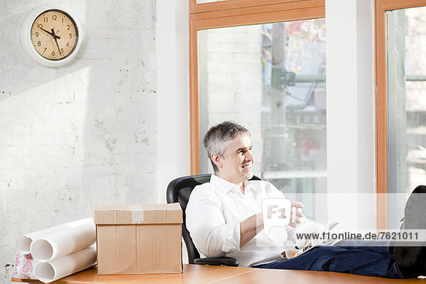 Businessman relaxing at desk in office