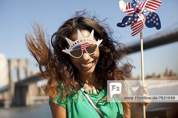 Woman in novelty sunglasses with pinwheel