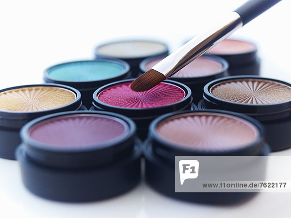 Close up of makeup brush and eyeshadows