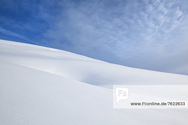 Recess in snow and sky with clouds at the Trattberg Austria