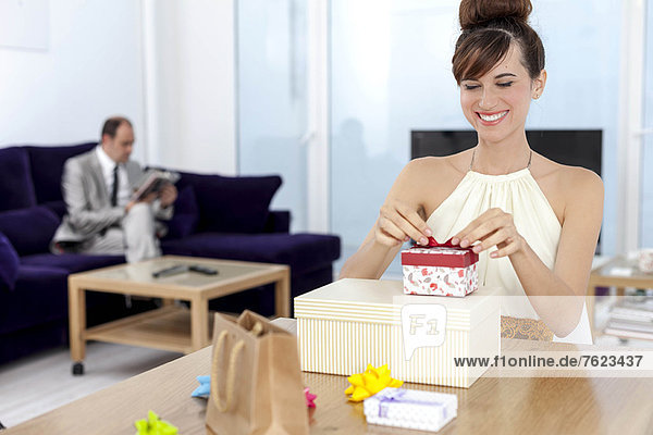 Woman opening presents at table