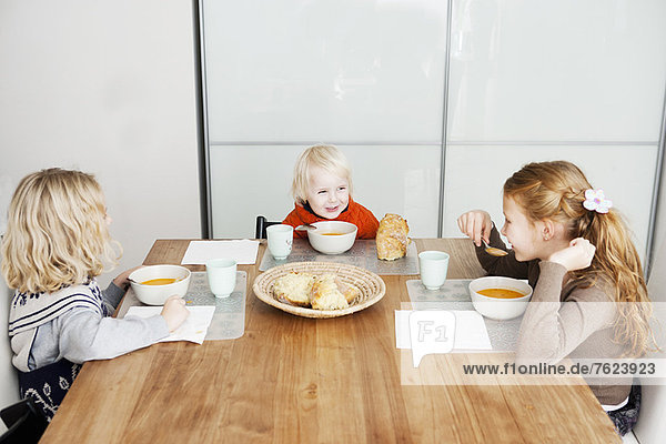 Kinder beim Mittagessen am Tisch