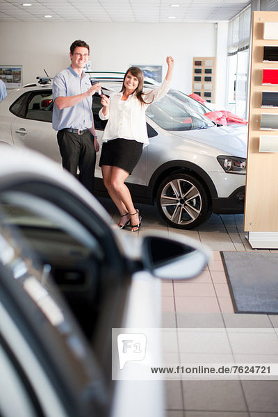 Woman buying new car from salesman
